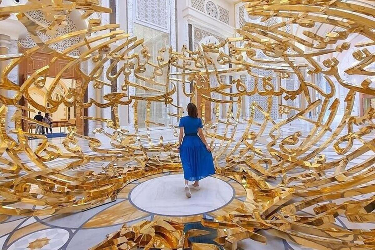 a woman in a blue dress standing in front of a giant gold room