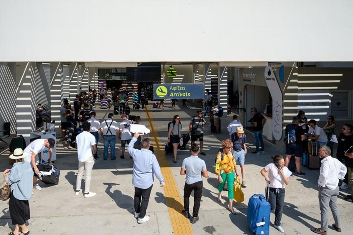 a group of people walking through an airport with luggage