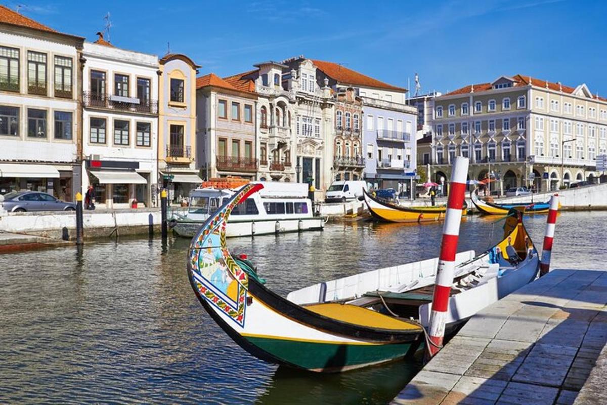 a group of boats docked in a canal with buildings