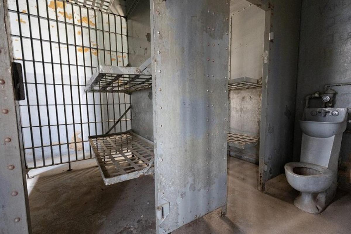 a jail cell with a toilet and a sink