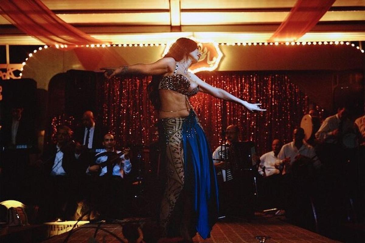 a woman dancing on a stage in front of a crowd
