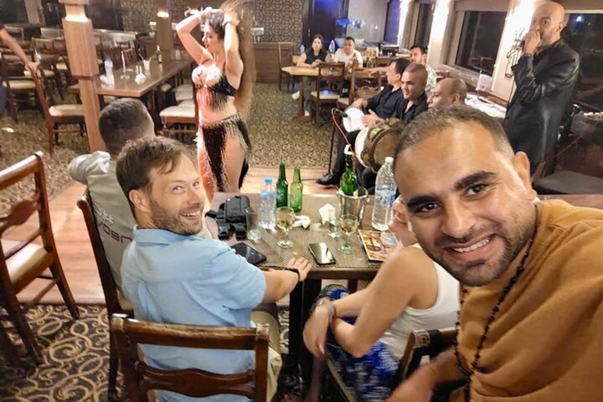 a group of people sitting at a table in a restaurant
