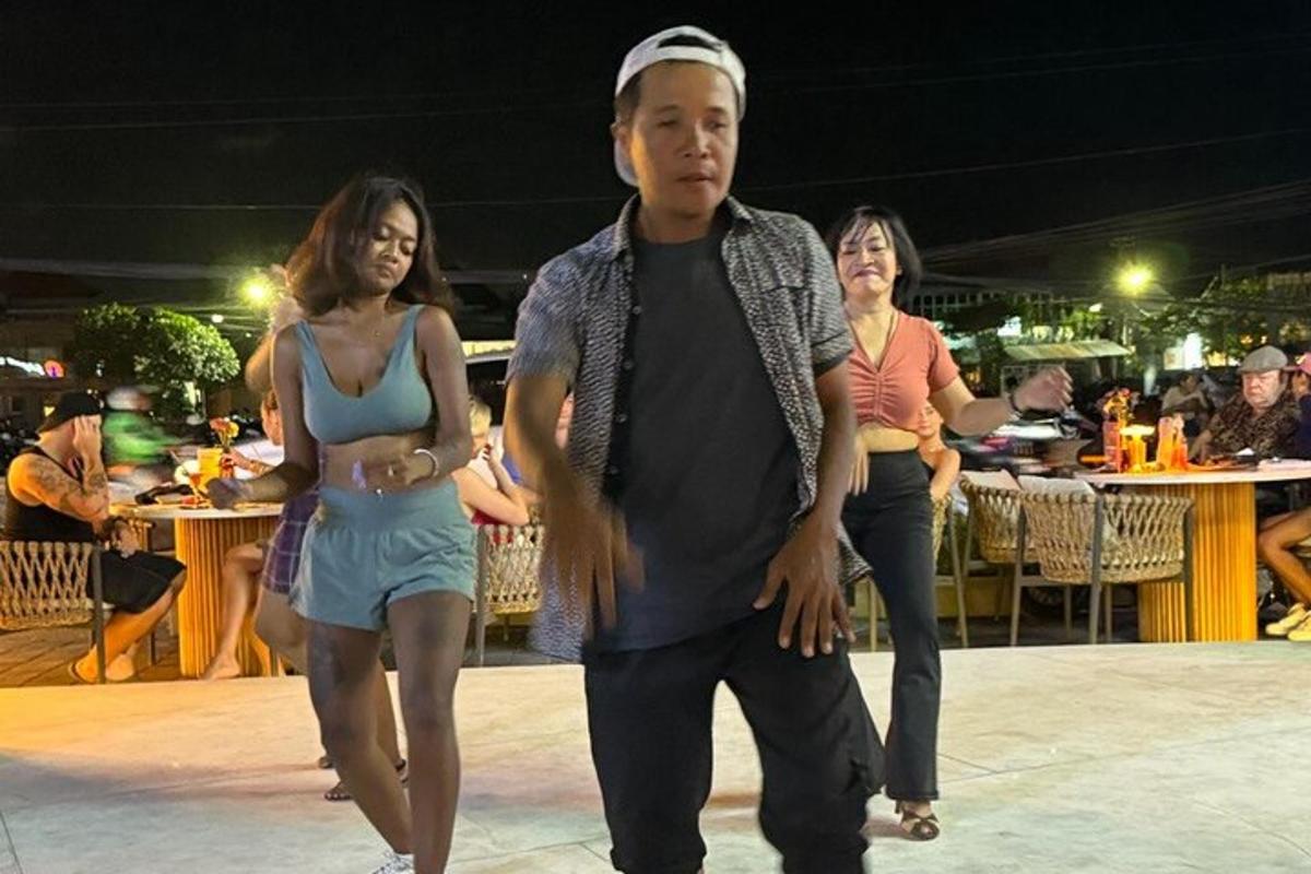 a man and a woman walking on a dance floor