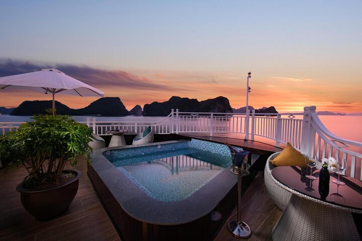 a bridge over a swimming pool with a view of the ocean