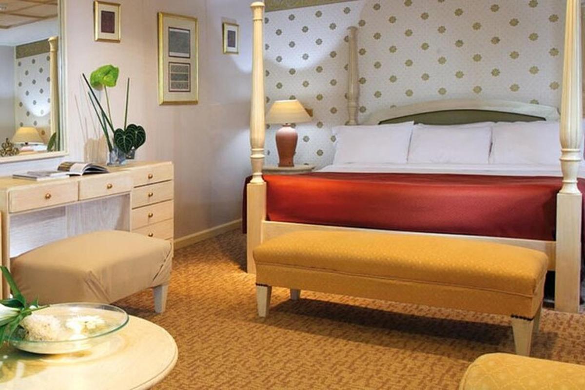 a bedroom with a bed and a chair and a table