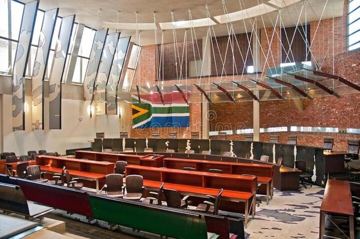 a lecture hall with rows of chairs and a flag