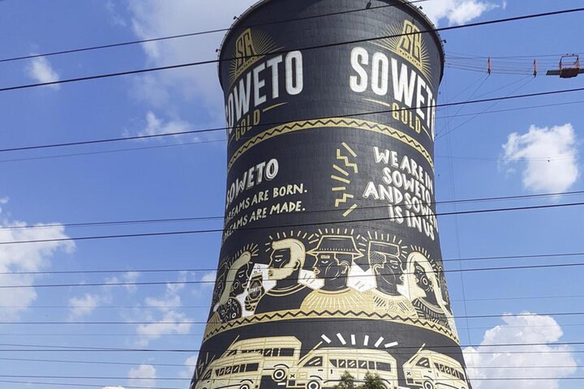 a black tower with a painting on the side of it