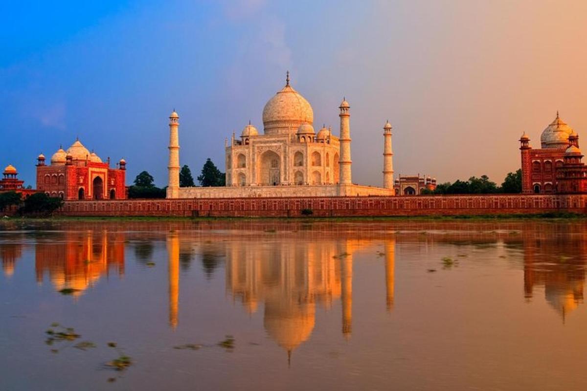 a view of the taj mahal with its reflection in the water
