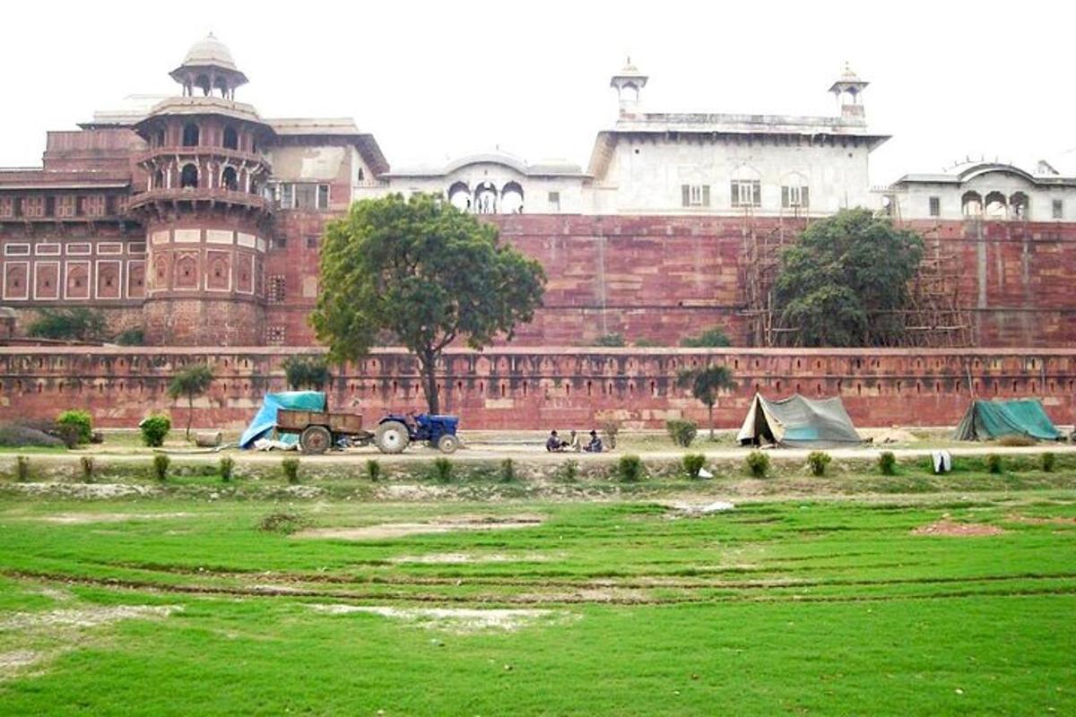 a large building with a green field in front of it