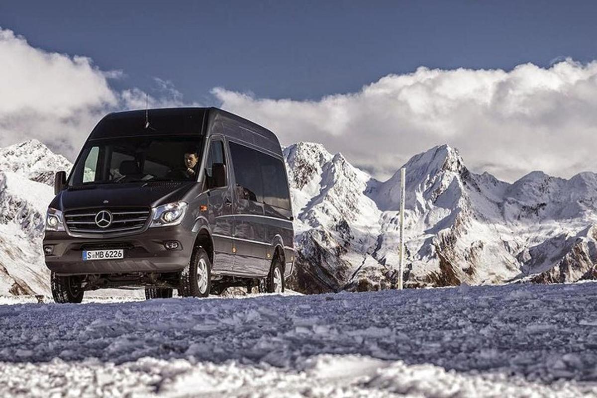 a van parked in front of a snow covered mountain
