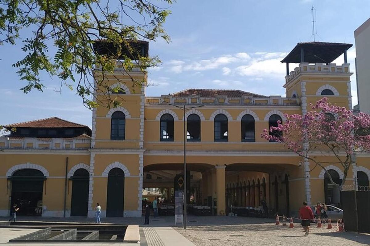 a large yellow building with people walking in front of it