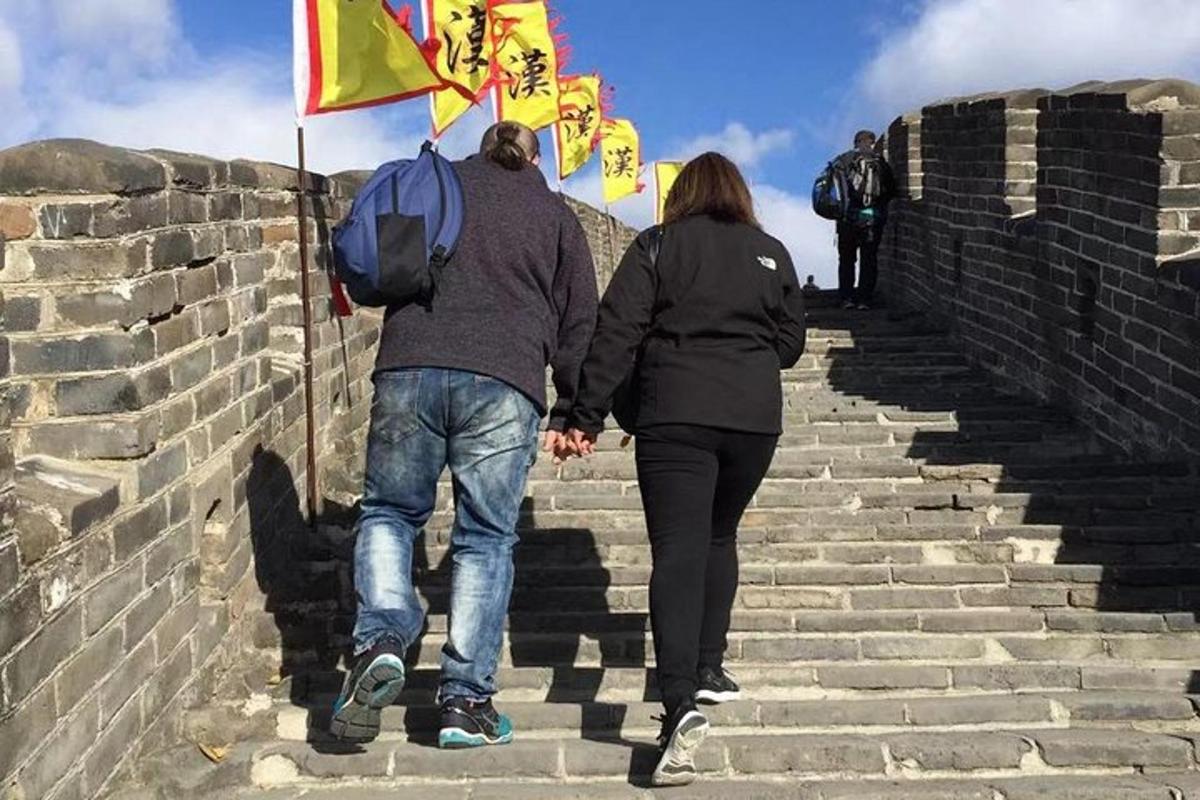a man and woman walking up some stairs with flags