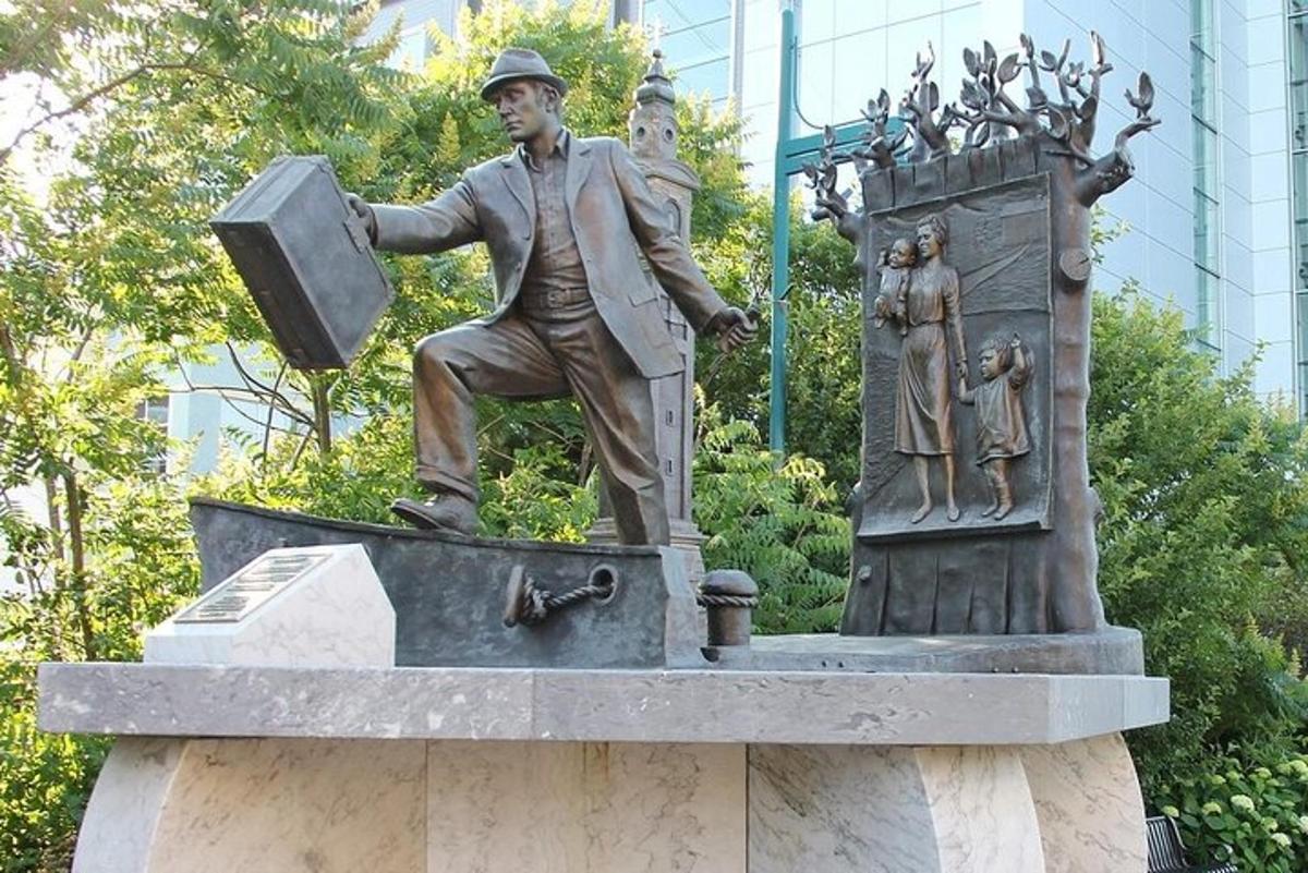 a statue of a man holding a briefcase on a fountain