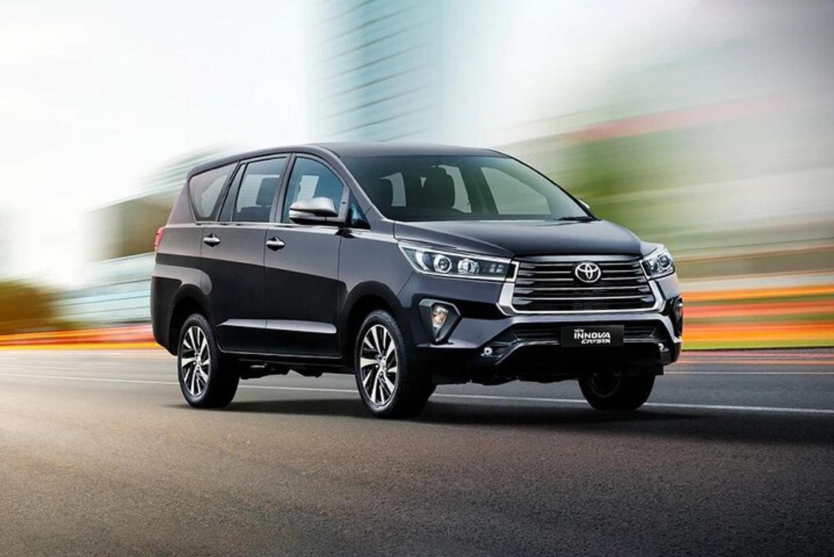 a black toyota fortuner driving down the street