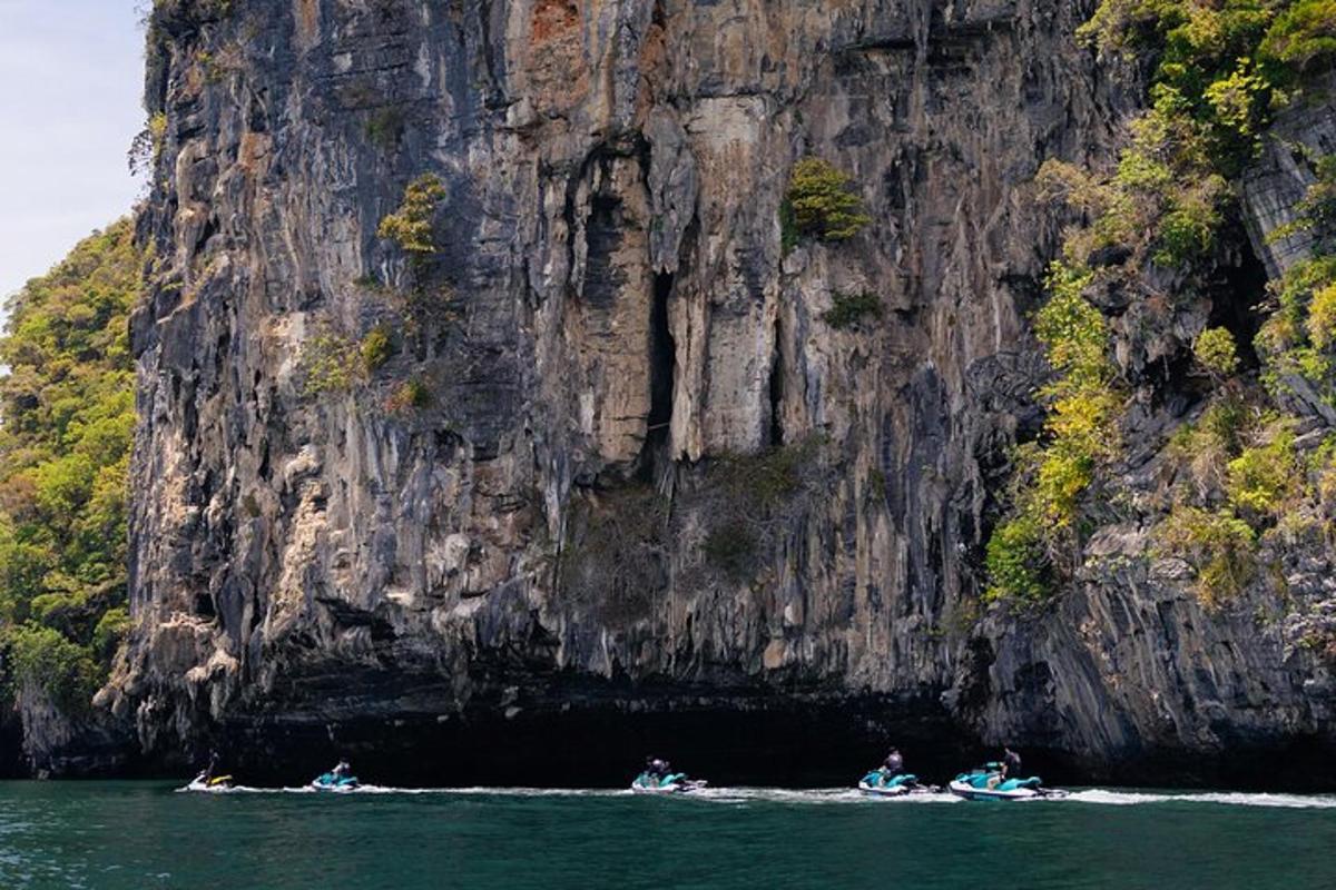 a group of people in kayaks in front of a mountain