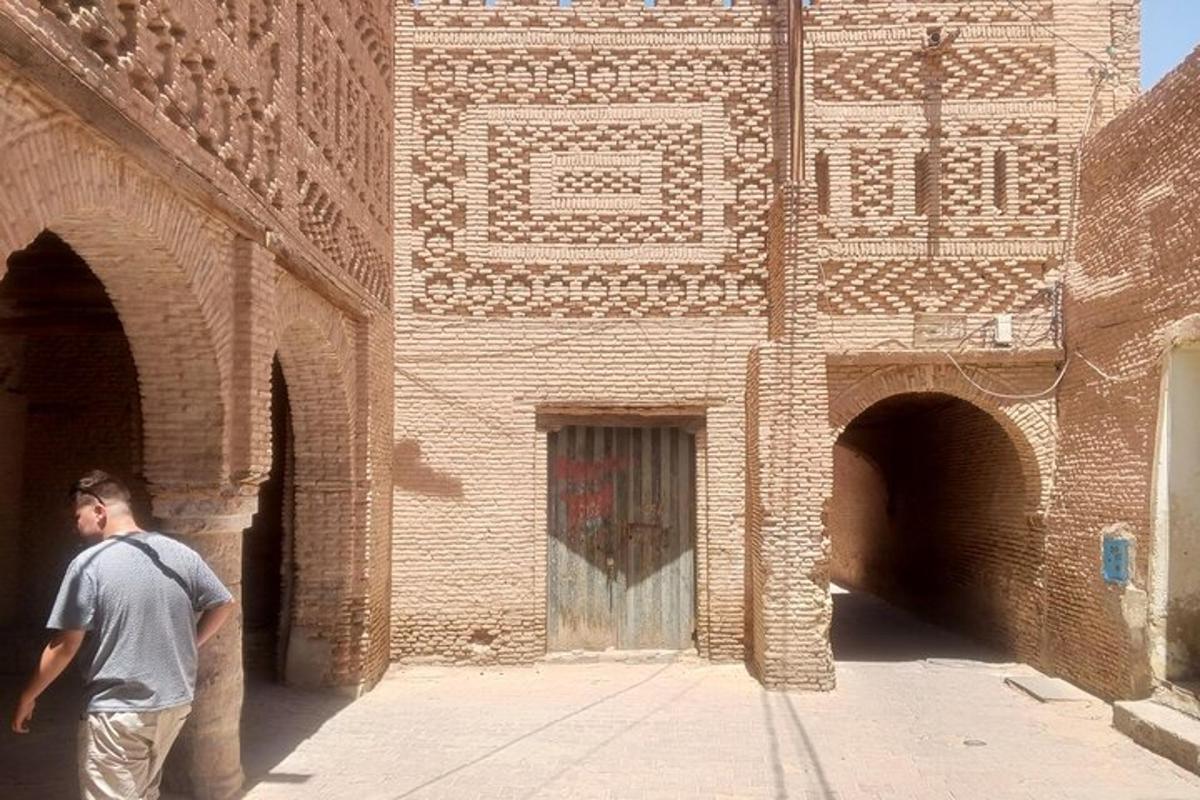 a man standing in front of a brick building