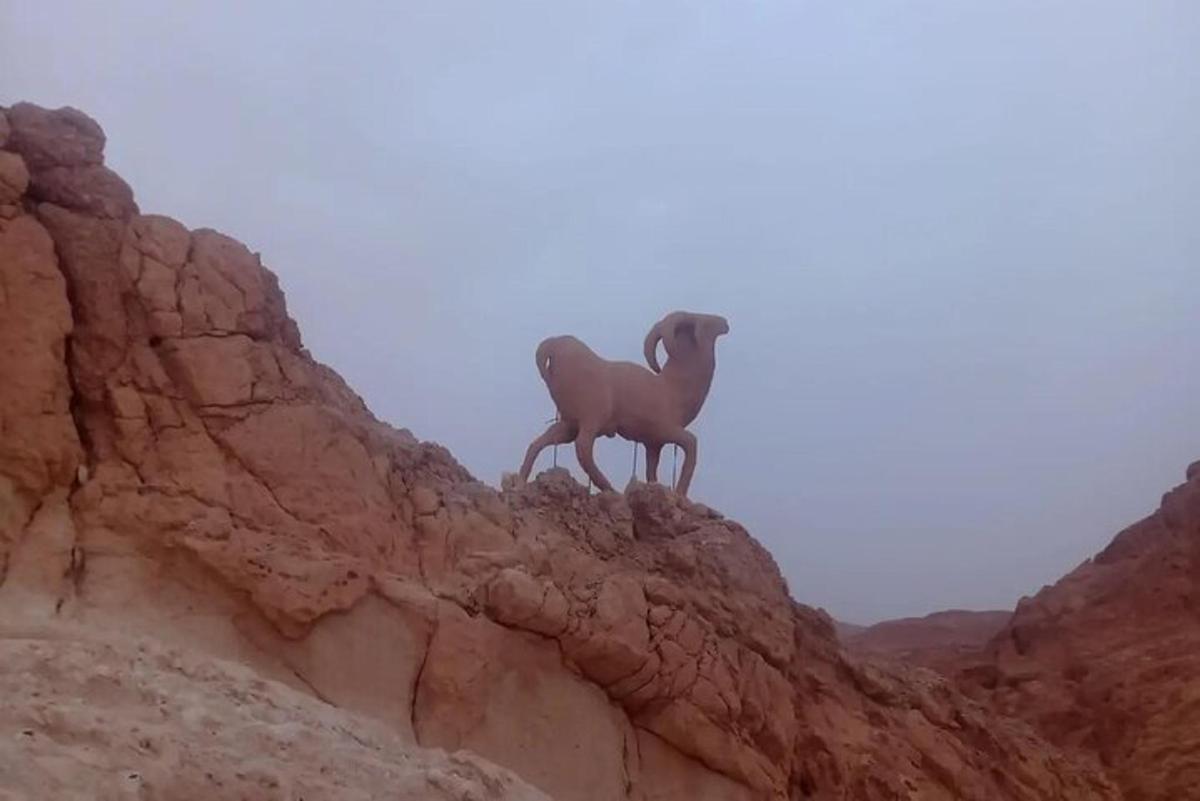 a statue of a horse on the side of a mountain