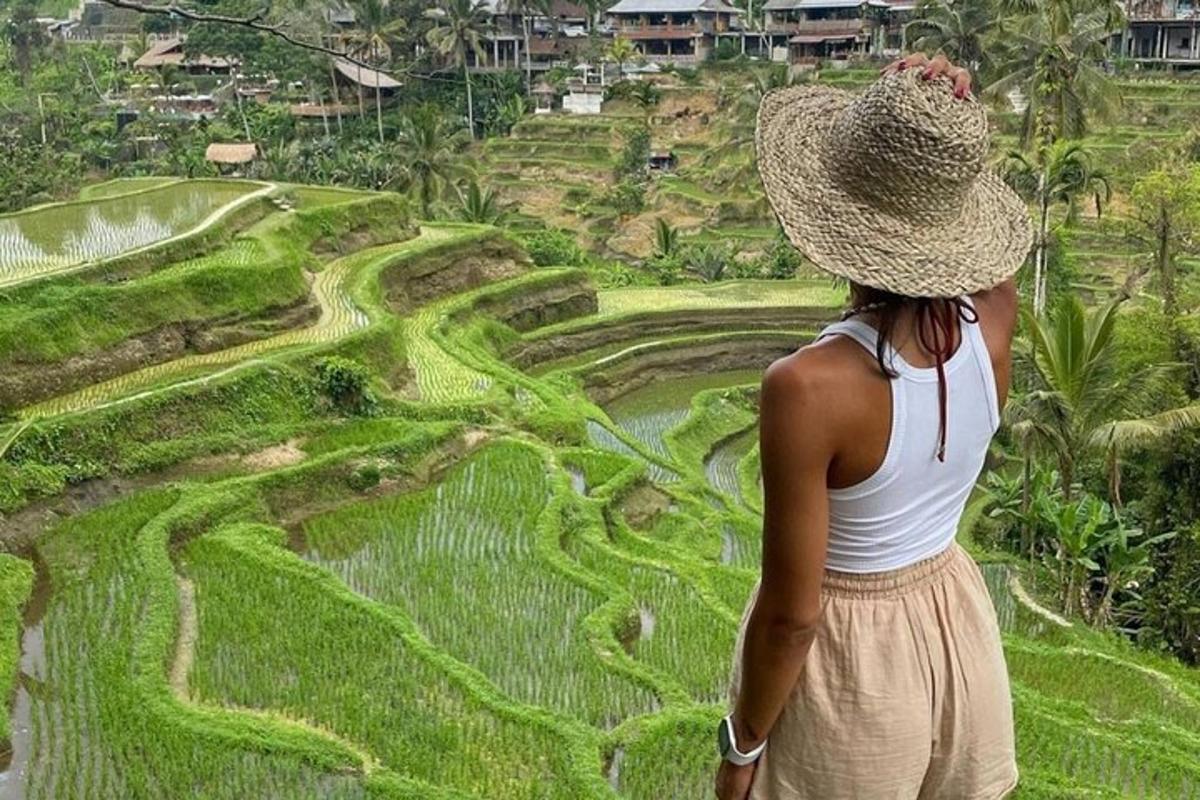 uma mulher com um chapéu de palha olhando para um campo