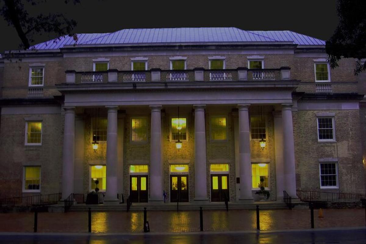 a large brick building with columns at night