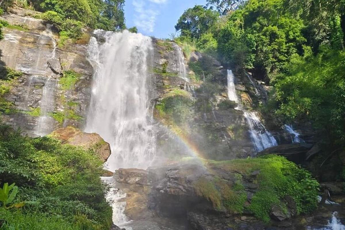 a rainbow at the end of a waterfall