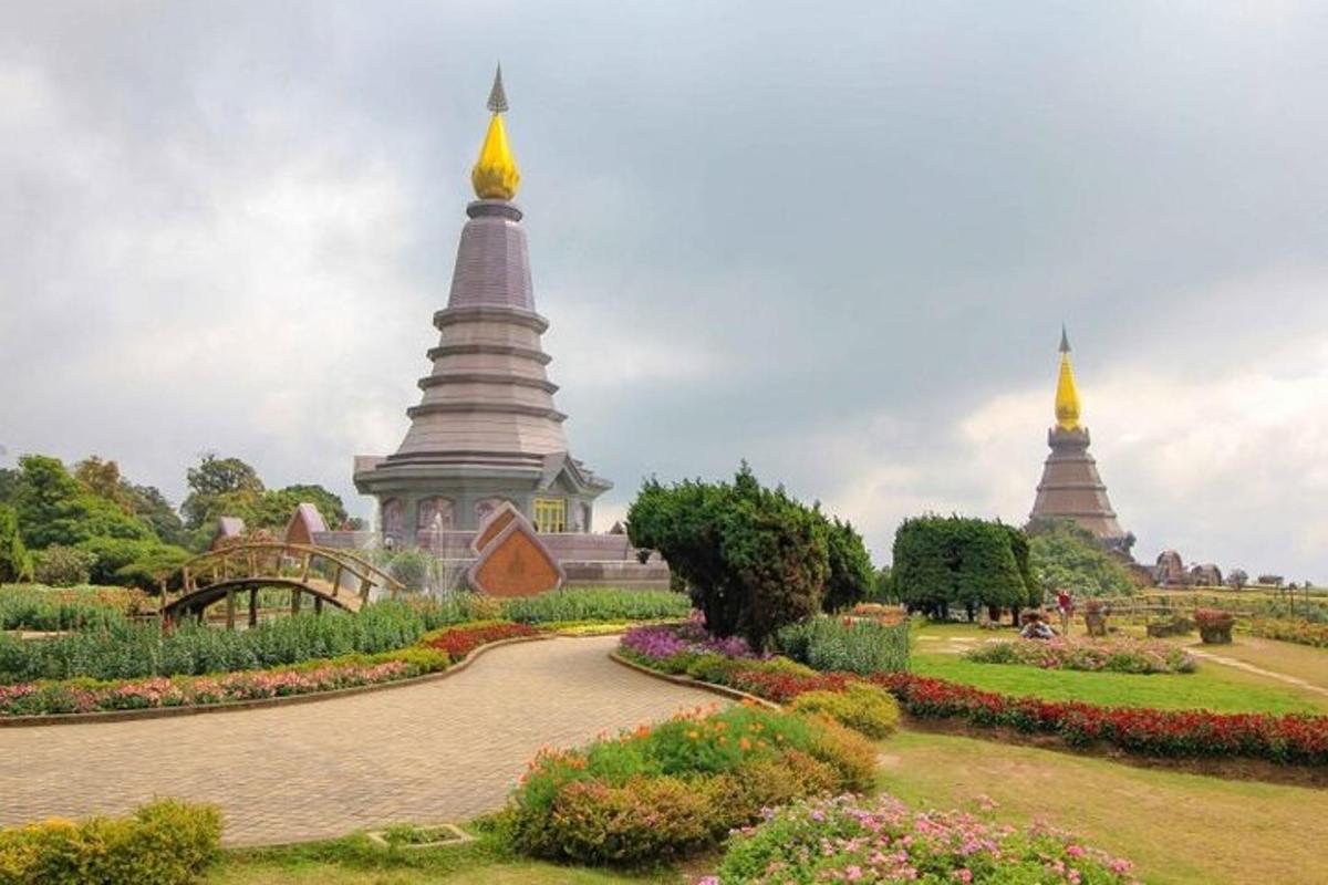 a park with two large towers in the background