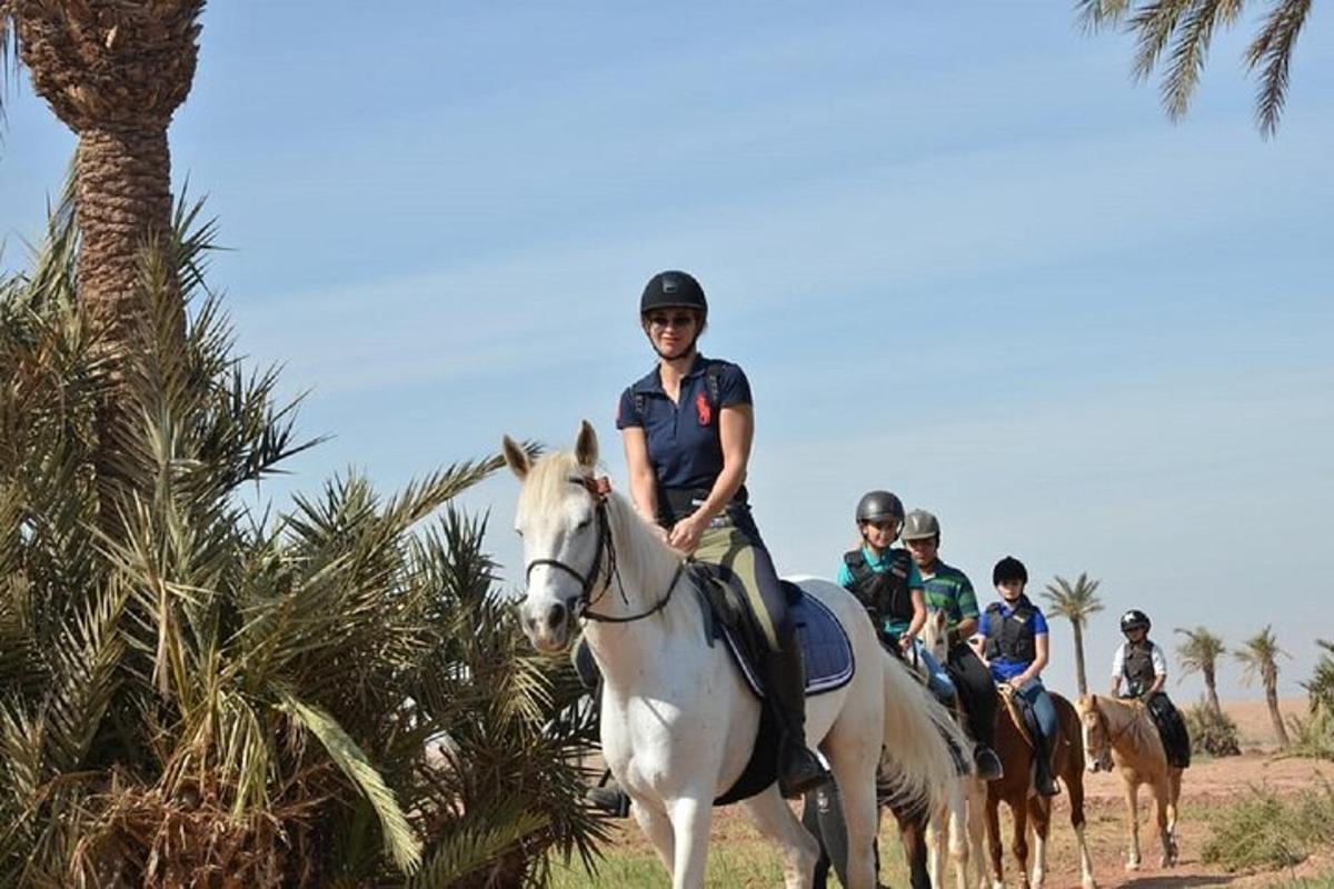 a group of people riding horses in the desert