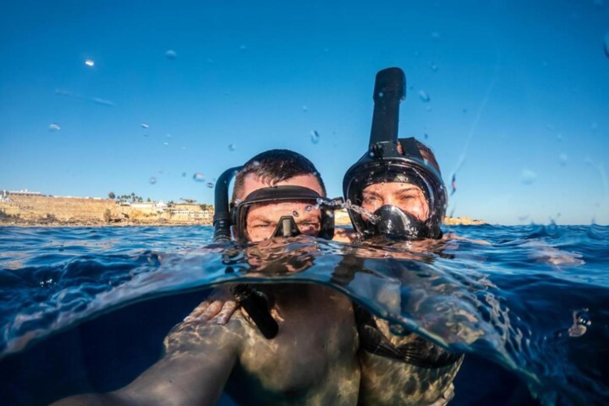 two men in the water with masks on