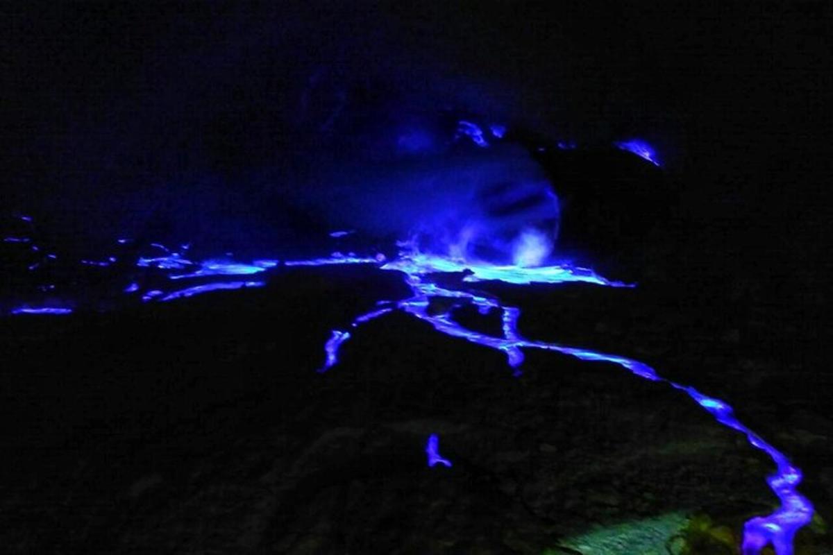 a night view of a river with blue lights