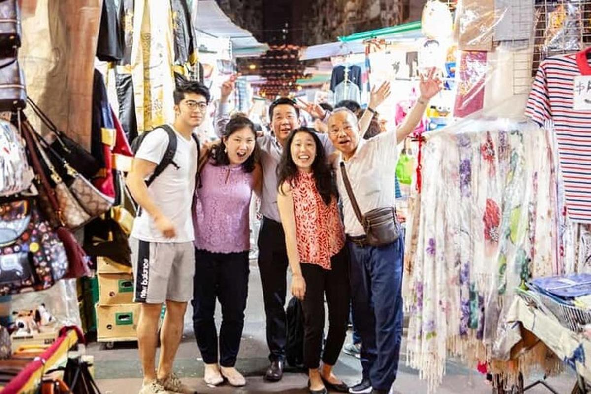 a group of people posing for a picture in a market