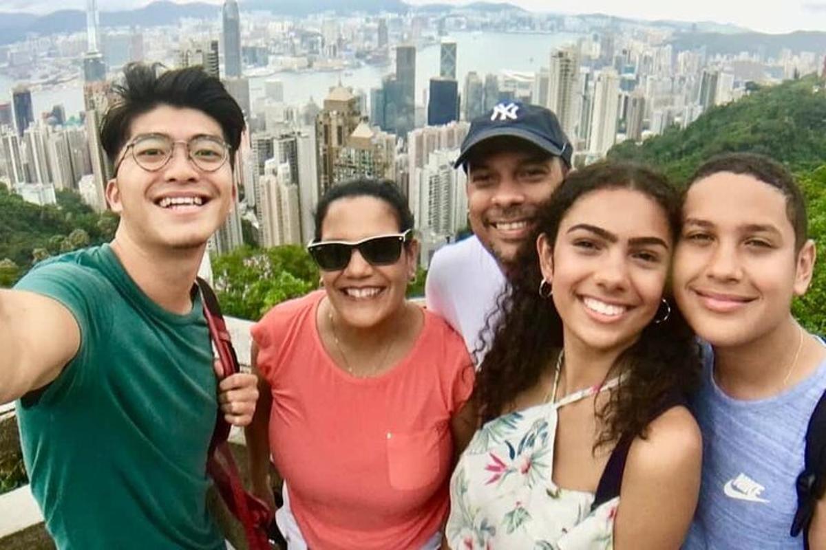 a group of people posing for a picture in front of a city