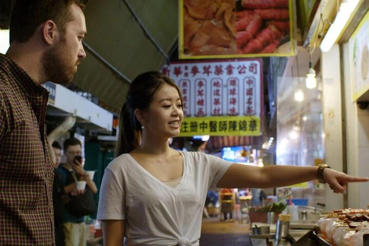 a man pointing at a woman in a market