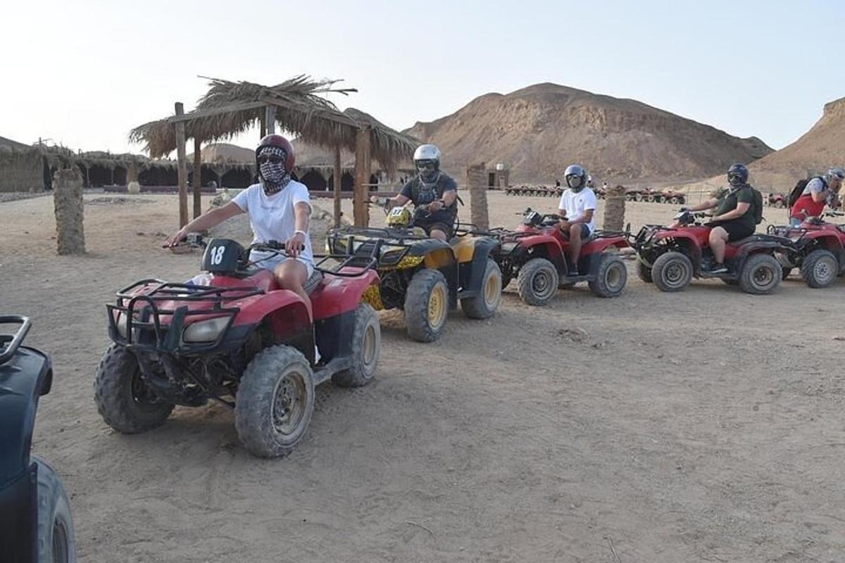 a group of people riding atvs in the desert