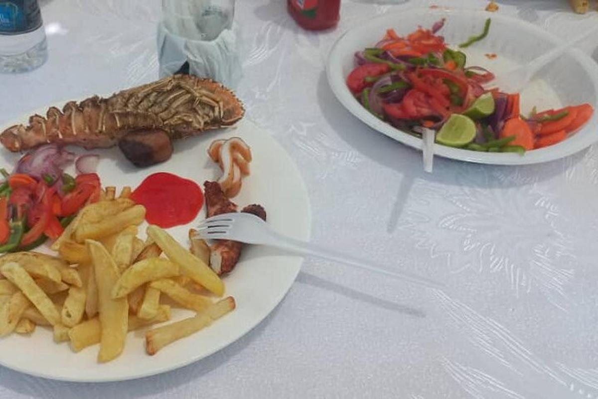 a table with two plates of food with french fries