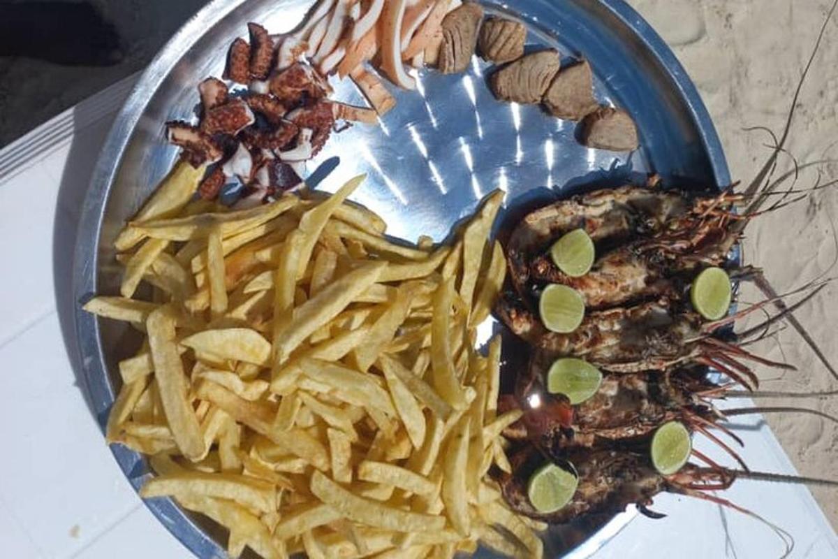 a plate of food with french fries and a lobster