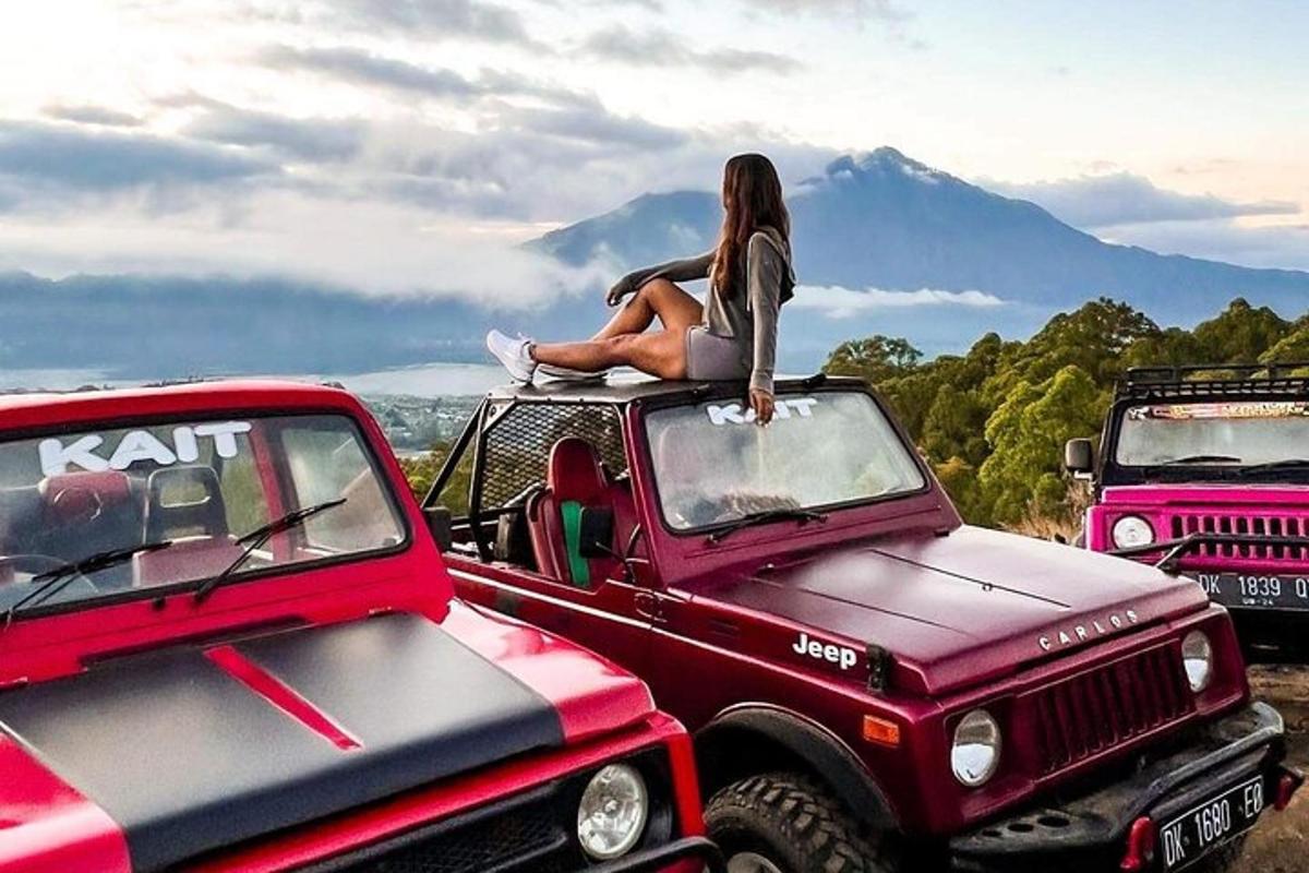 a woman sitting on the top of a red truck