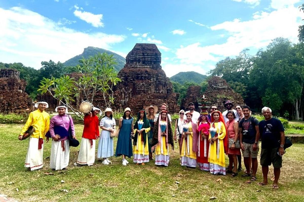 a group of people posing for a picture in front of a temple