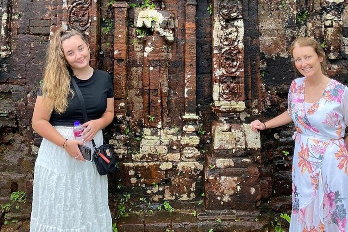 two women standing in front of a building