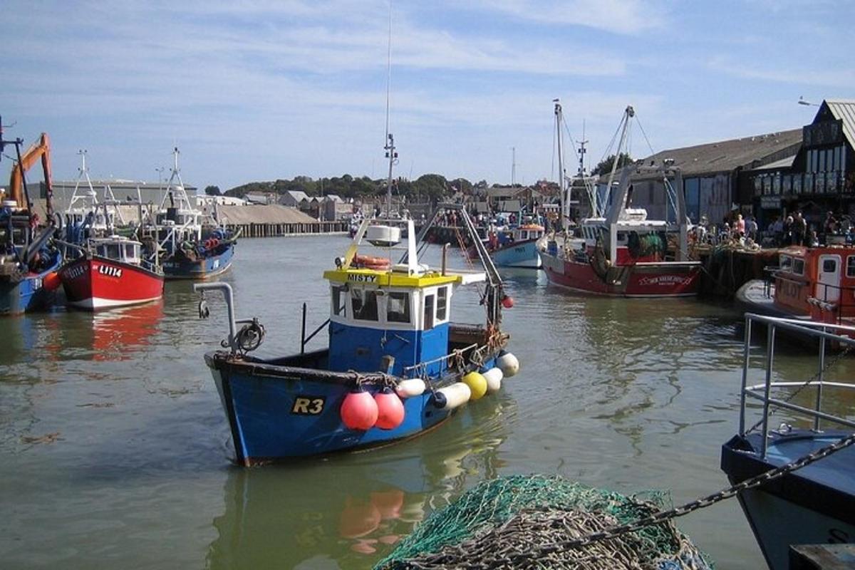 a boat is docked in a harbor with other boats