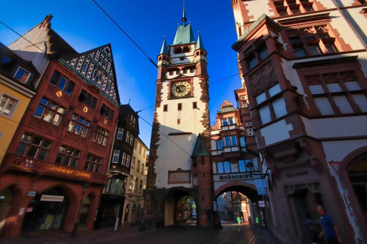 a clock tower in the middle of a city street