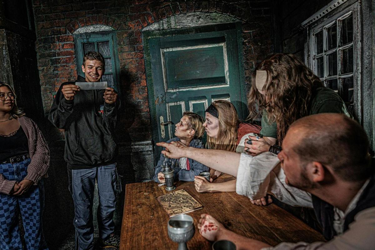 a painting of a group of people sitting around a table