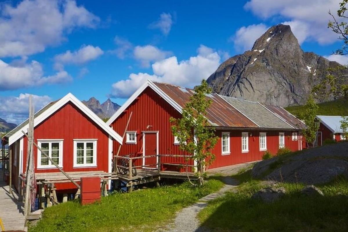 a red house with a mountain in the background