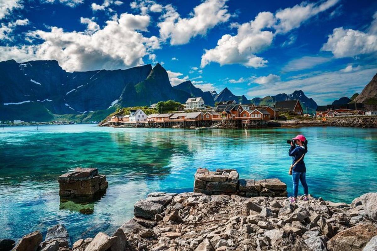 a person standing on rocks near a body of water