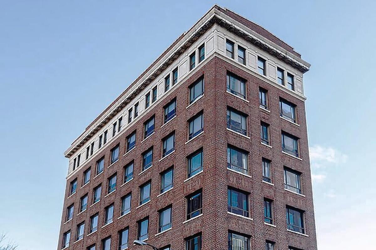 a tall brick building against a blue sky