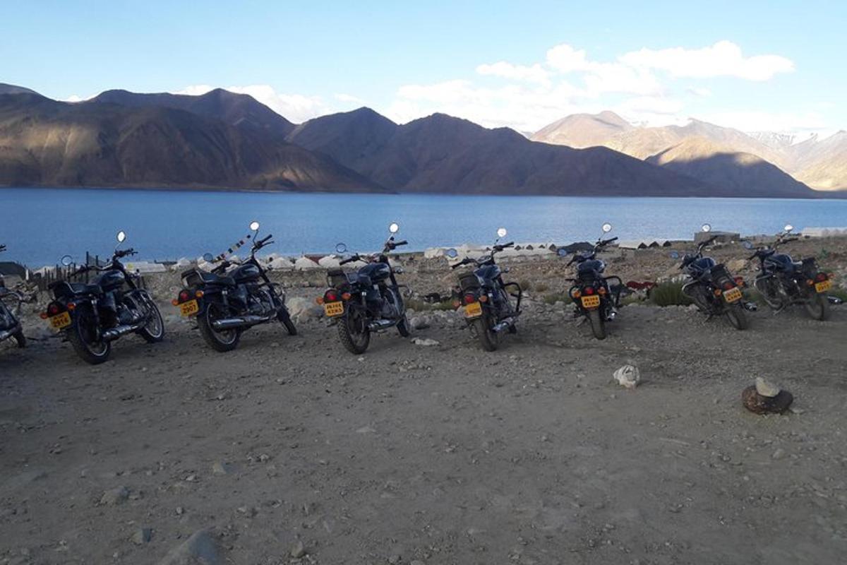 a group of motorcycles parked next to a body of water