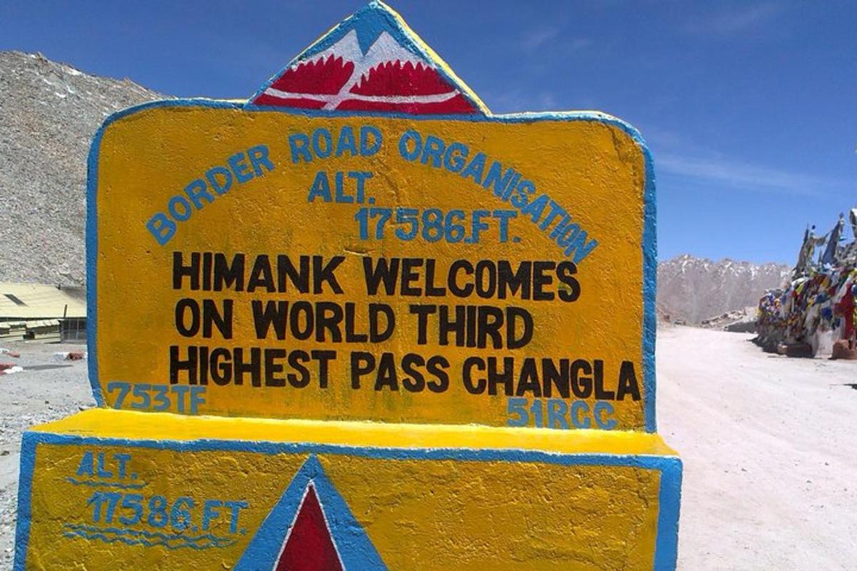 a yellow sign on the side of a mountain