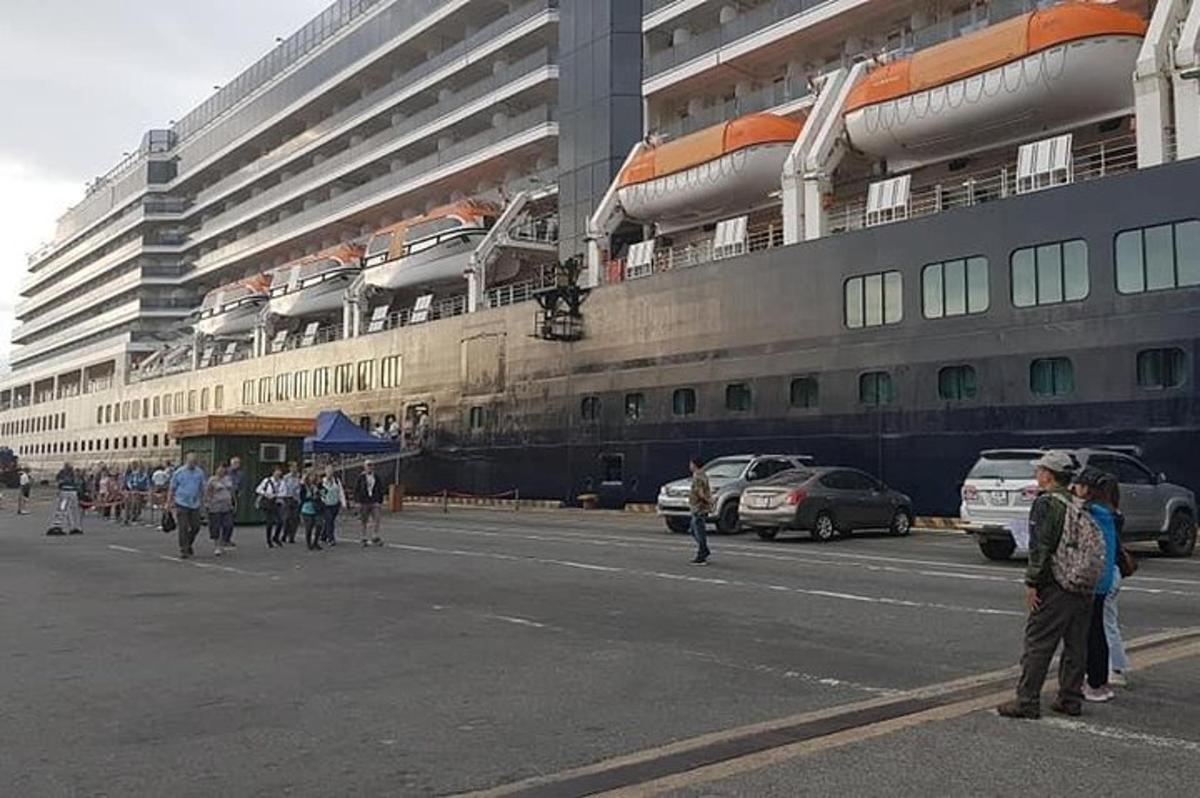 a large cruise ship parked in front of a building