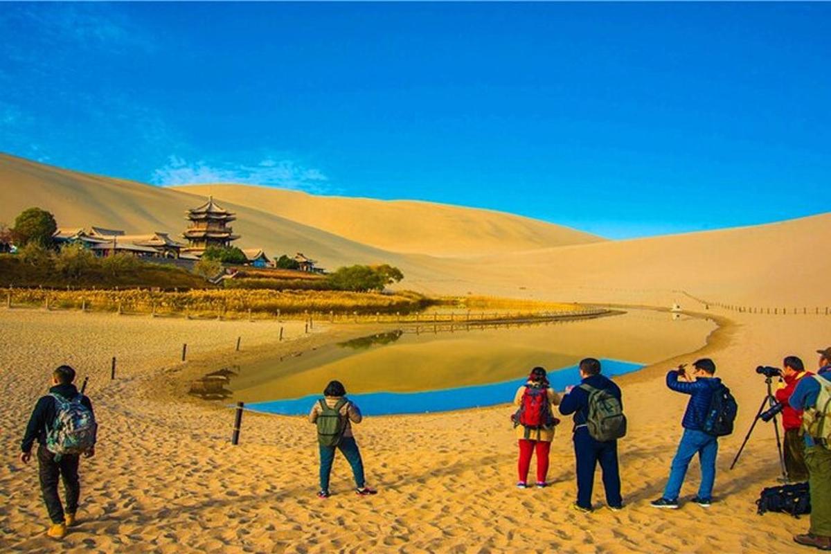 a group of people standing in the sand in the desert