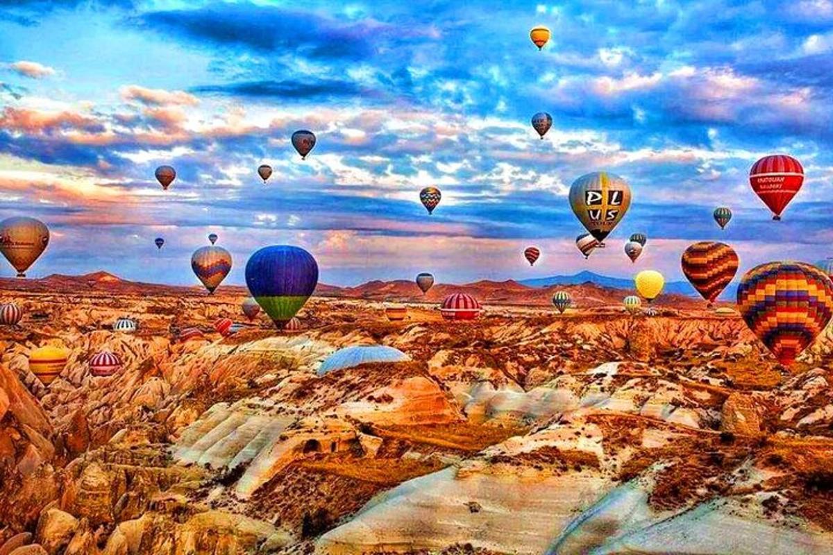 a bunch of hot air balloons flying in the sky