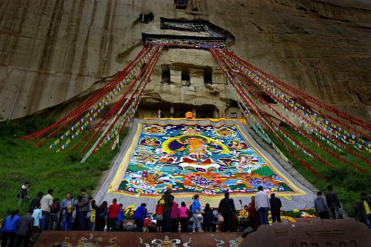 a group of people standing in front of a large painting