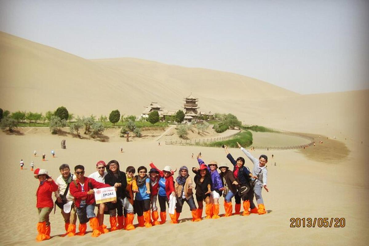a group of people posing for a picture in a desert